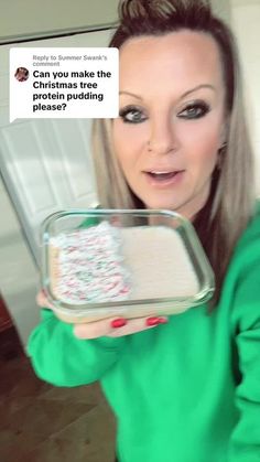 a woman holding a tray with cake in it