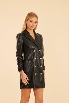 This season, mix it up with a nod to retro glamour in our Faux Leather Blazer Dress, a chic piece that channels the bold spirit of the ‘80s. This edgy blazer dress boasts a structured silhouette with a faux leather finish, perfect for making a statement while keeping warm this season. It features a double-breasted design with metallic buttons, and ruched sleeves for even more of a vintage flair. Faux leather Double-breasted Metallic buttons Ruched three-quarter sleeves Available in Black and Sca Chic Fitted Blazer Dress With Button Closure, Chic Knee-length Blazer For Night Out, Spring Evening Knee-length Blazer, Knee-length Evening Blazer For Spring, Tailored Knee-length Party Blazer, Fitted Double-breasted Blazer Dress For Night Out, Tailored Knee-length Blazer Dress For Party, Tailored Knee-length Party Blazer Dress, Chic Single Breasted Evening Blazer Dress