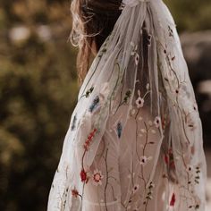 a woman wearing a veil with flowers on it