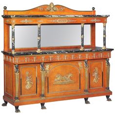 an old fashioned wooden cabinet with mirrors on it's sides and carvings around the top