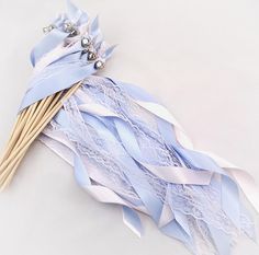 a bunch of blue and white streamers on top of each other with pins in them