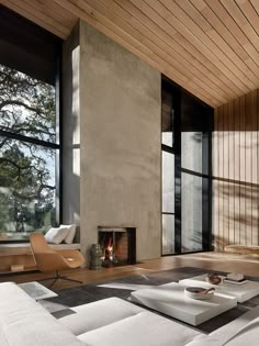 a living room filled with lots of windows and furniture