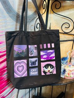 a black tote bag with images of hearts, butterflies and other things on it