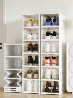 a white shelf with several pairs of shoes on top of it next to a speaker