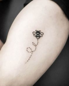 a small tattoo on the back of a woman's left arm that says love