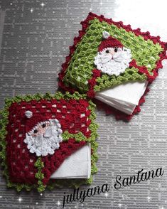 two crocheted santa claus napkins on top of each other with white and green trim