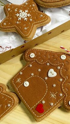 three decorated cookies in a box on a table