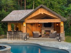 an outdoor living area next to a swimming pool with chairs and tables around the fire pit