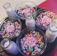 there are several bowls of cereal and milk on the table