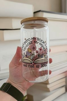 a person holding a jar with an open book on it