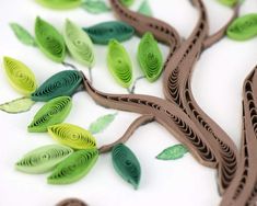 a paper tree with green leaves on it