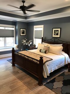 a large bed sitting inside of a bedroom on top of a hard wood floor