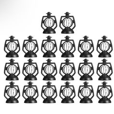 twelve black candlesticks are arranged in the shape of an ornament and have circular rings on them