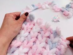 someone is crocheting the yarn for a necklace