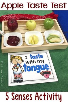 a wooden tray filled with apples and other foods