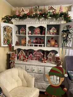 a white hutch filled with lots of christmas decorations