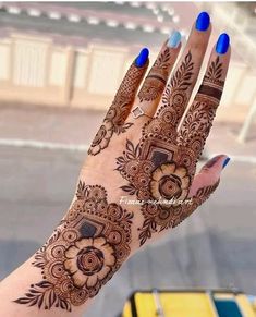 a woman's hand with henna tattoos on it