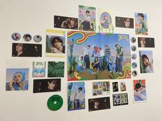 the wall is covered with many pictures and magnets, including one that has a green disc