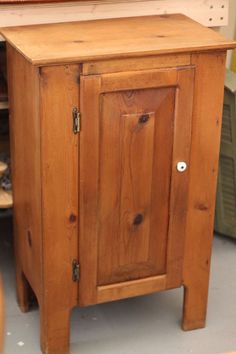 a small wooden cabinet sitting inside of a room