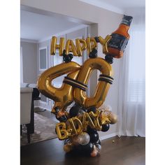 a balloon shaped like the number 50 with an orange bottle on top and balloons attached to it