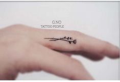 a person's hand with a small tattoo on it