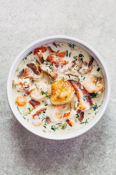 a white bowl filled with seafood chowder