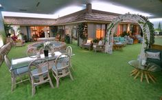 a large open living room with lots of furniture and decor on the grass flooring