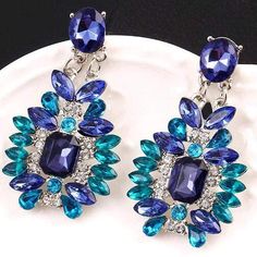 These are super bling-a-fied and just WOW! Dress them up or bling up your t-shirt and jeans! They really channel the colors of the ocean. Standard post earrings. Lead and Nickle Free. Approximately 2" long. GORGEOUS statement bling! Black Crystal Earrings, Popular Jewelry, Crystal Accessories, Blue Gems, Crystal Stud Earrings, Crystal Drop Earrings, Trendy Jewelry, Rhinestone Earrings, Blue Earrings