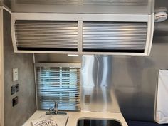 a kitchen area with sink, stove and refrigerator