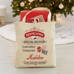 a tote bag sitting in front of a christmas tree