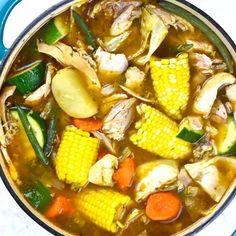 a pot filled with soup and vegetables on top of a table