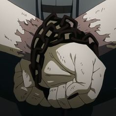 a person with chains on their hands is chained to a chair in front of them