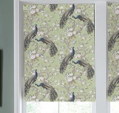 the window is decorated with peacocks on green wallpaper and matching blinds in white frames