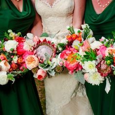 three bridesmaids in green dresses hold bouquets of flowers and greenery on their wedding day