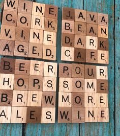 four scrabble tiles with words written on them sitting next to each other in front of a blue wooden background