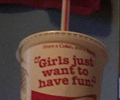 a paper cup with a straw in it that says girls just want to have fun