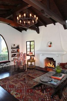 a living room filled with furniture and a fire place in the middle of a room