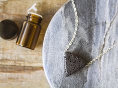 Accessorize with a purpose with our Wellness & Balance Lava Necklaces. Lava stones' porous nature allows it to easily absorb your favorite oil while your body heat contributes to gently diffusing scents to create your very own personal and wearable aromatherapy diffuser! You can even transform your lava experience each day by adding a new fragrance or essential oil. This set includes 1 diffuser necklace and a 2ml bottle of oil. To order, simply select a necklace and type in your choice of an Oil Bar, Diffuser Jewelry, Aromatherapy Diffuser, Young Living Oils, Diffuser Necklace, Triangle Pendant, Aromatherapy Diffusers, New Fragrances, Lava Stone