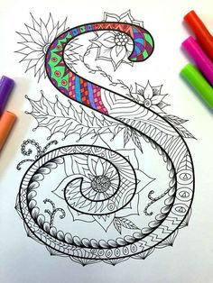 an adult coloring book with some markers and crayons