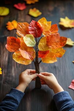 Child holding a handmade autumn tree with colorful paper leaves. Dried Leaves Crafts, Leaves Crafts For Toddlers, Autumn Leaves Diy, Crafts With Leaves, Easy Fall Crafts For Kids, Nature Crafts Kids, Leaves Craft, Thanksgiving Leaves, Autumn Leaves Craft