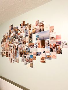 a wall with many pictures hanging on it