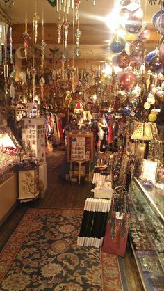 a store filled with lots of different types of ornaments and lights hanging from the ceiling