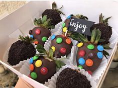 chocolate covered strawberries with m & m candies in a box