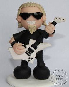 a figurine of a man with a guitar in his hand and sunglasses on