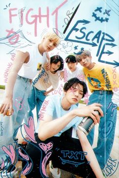 a group of young men standing next to each other in front of a graffiti covered wall