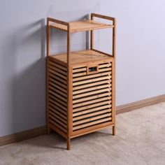 a wooden shelf with a drawer on top of it next to a wall and carpeted floor