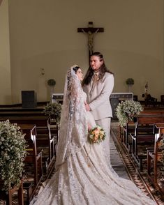 a bride and groom standing in front of the alter