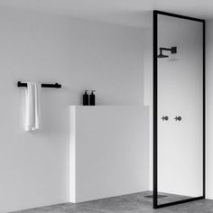 an empty bathroom with black and white accessories