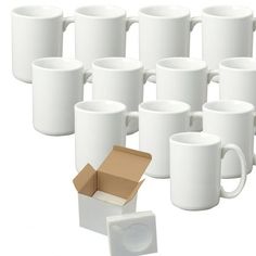 there are many white coffee mugs in the box and one has a cardboard box