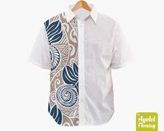 "IF YOU NEED YOUR ITEMS TO ARRIVE BY SPECIFIC DATE PLEASE UPGRADE TO EXPRESS SHIPPING AT THE CART. This gorgeous Polynesian short sleeve men's dress shirt is featuring half white light brown and blue ulu floral design. If you would rather this shirt was in another color or combination of colors please get in touch and let me know and I will do my best to accommodate you. This unique and eye catching men's dress shirt with short sleeves is the perfect shirt for daytime or evening casual wear. The Fitted White Hawaiian Shirt, White Fitted Hawaiian Shirt, Polynesian Dress, Button Up Shirt Men, Floral Button Up Shirt, Maori Designs, Batik Art, Half Shirts, Batik Shirt